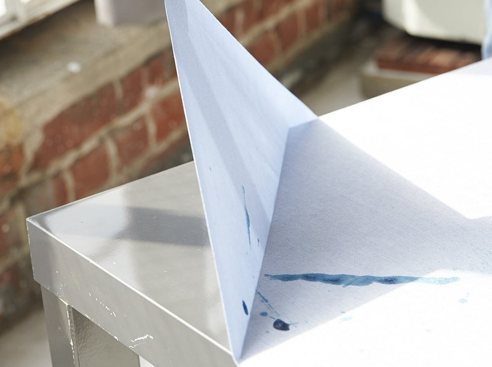 peeling off Katch protective favrick from a table