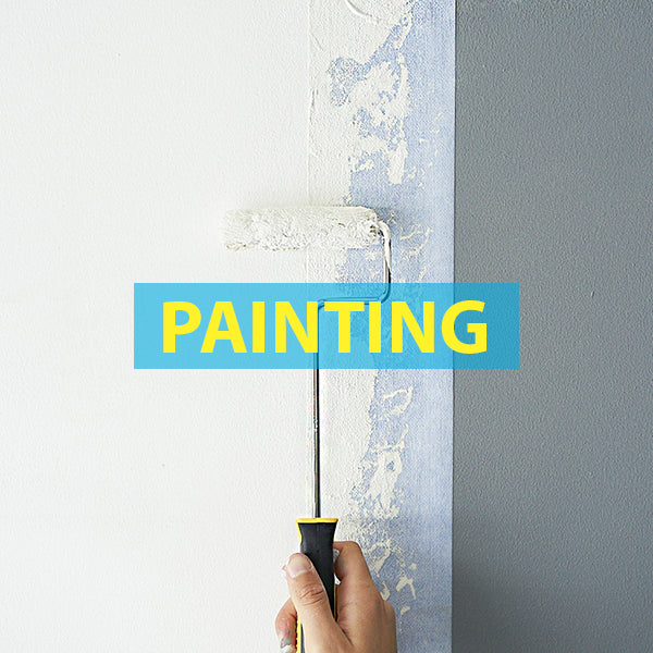 a person painting a wall protected by Katch extra wide painters tape
